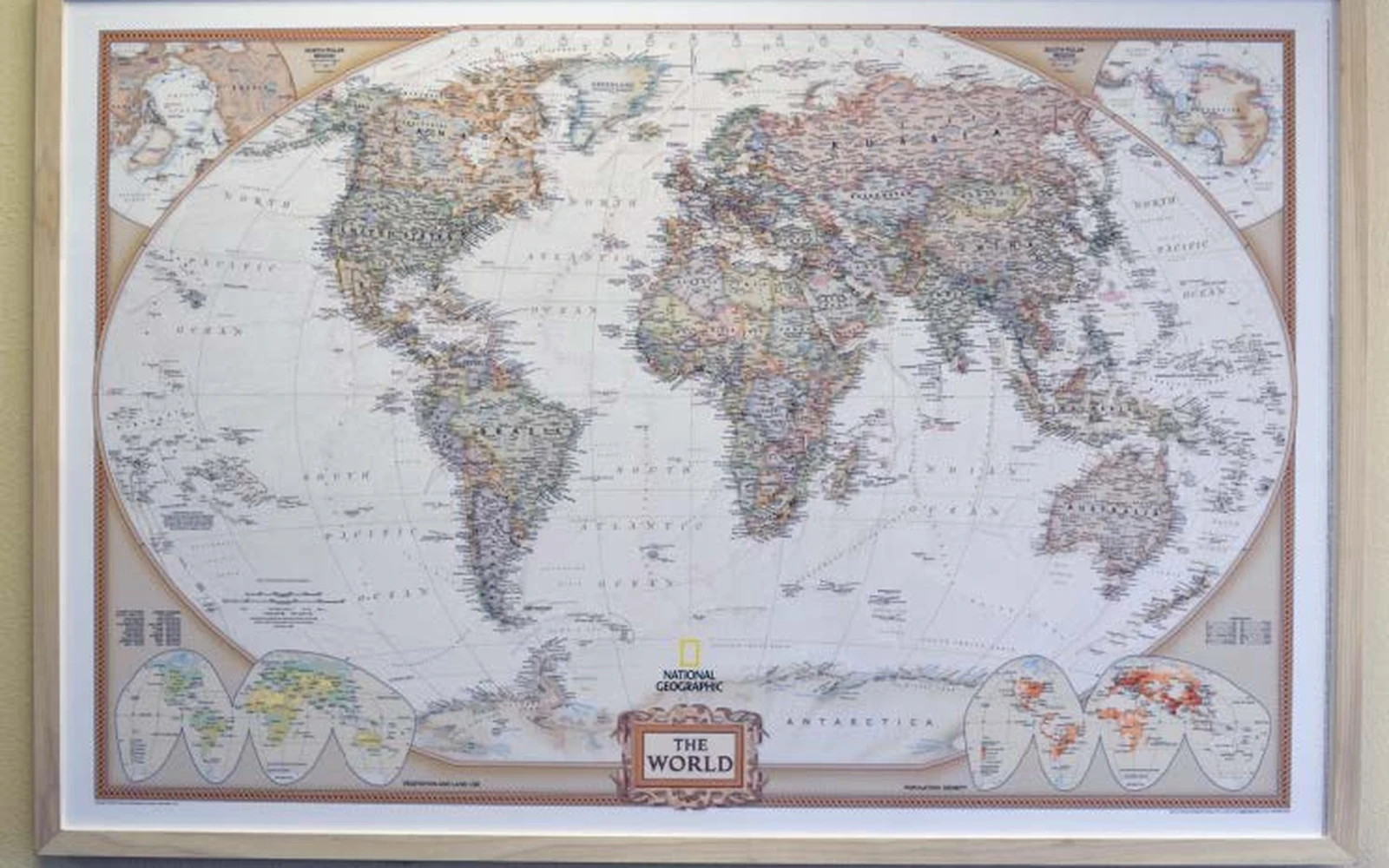 A framed world map hanging on a wall