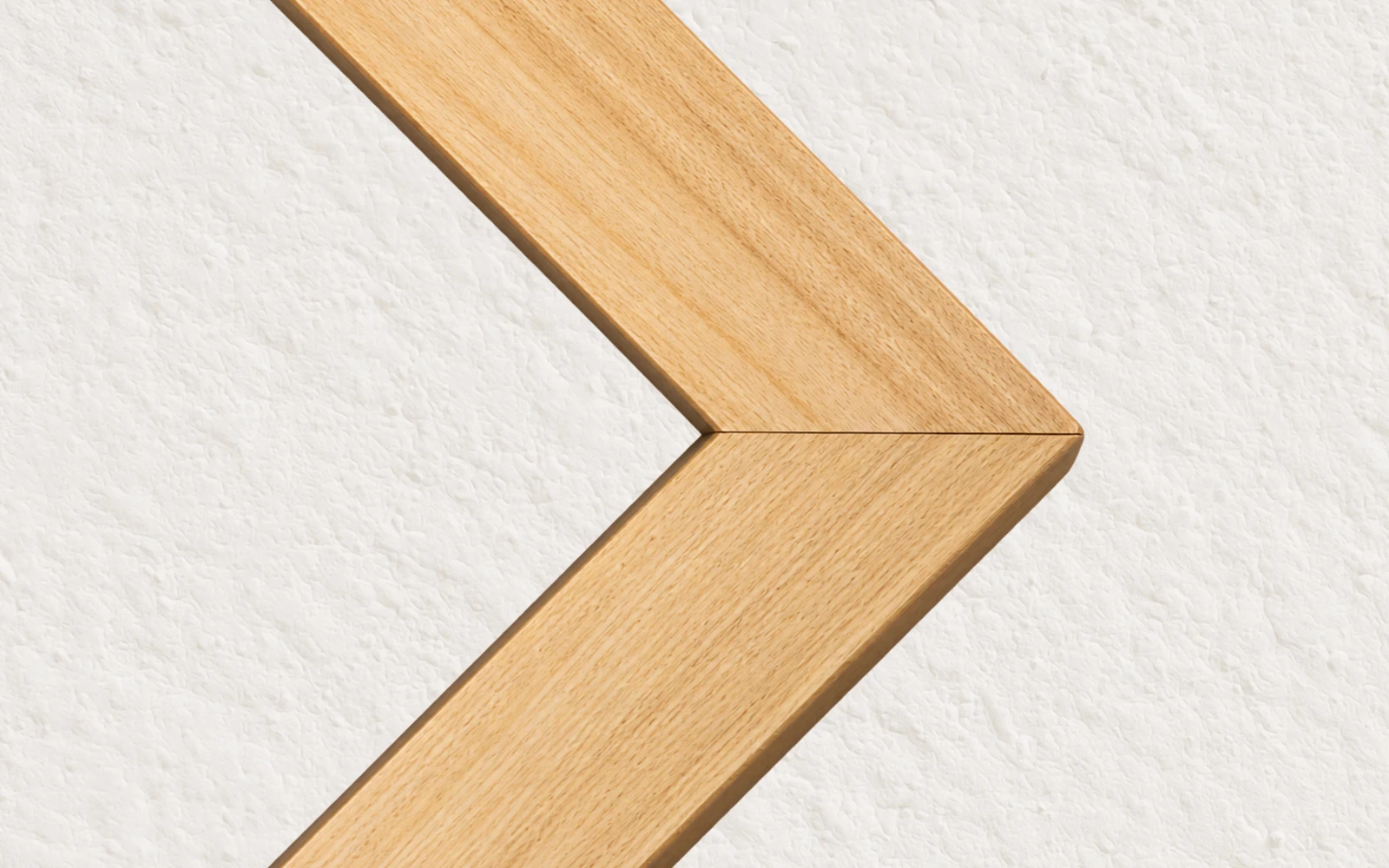 The mitred corner of an unfinished pine frame