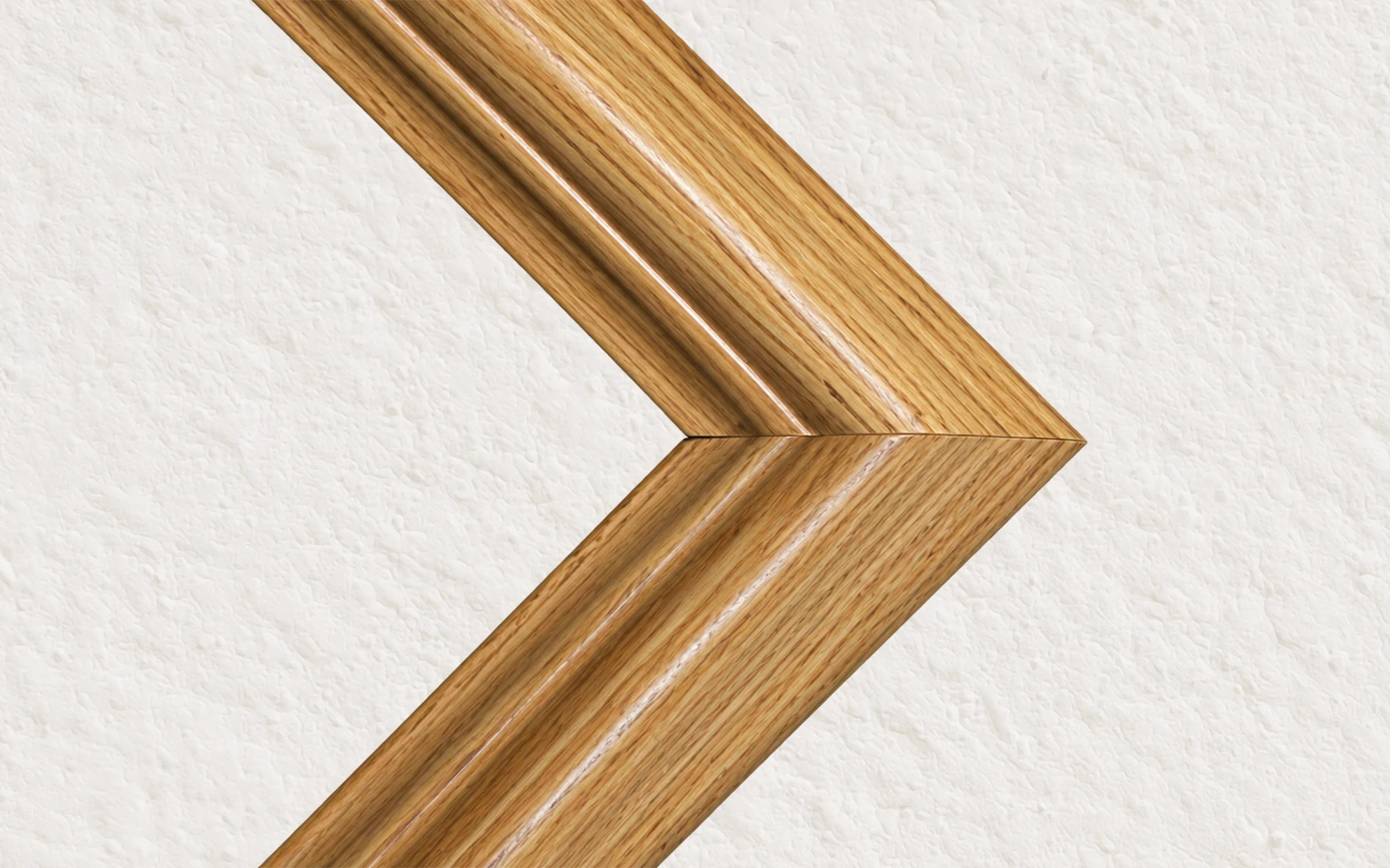 The mitred corner of a light oak stained wood frame