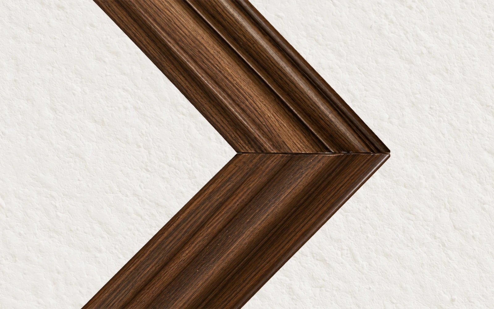 The mitred corner of a dark oak stained frame