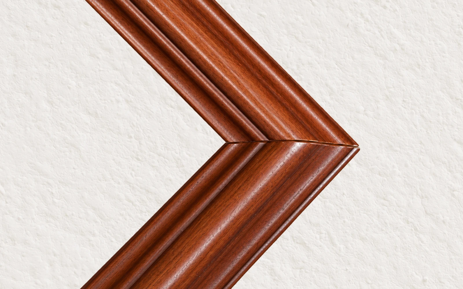 The mitred corner of a cherry stained frame