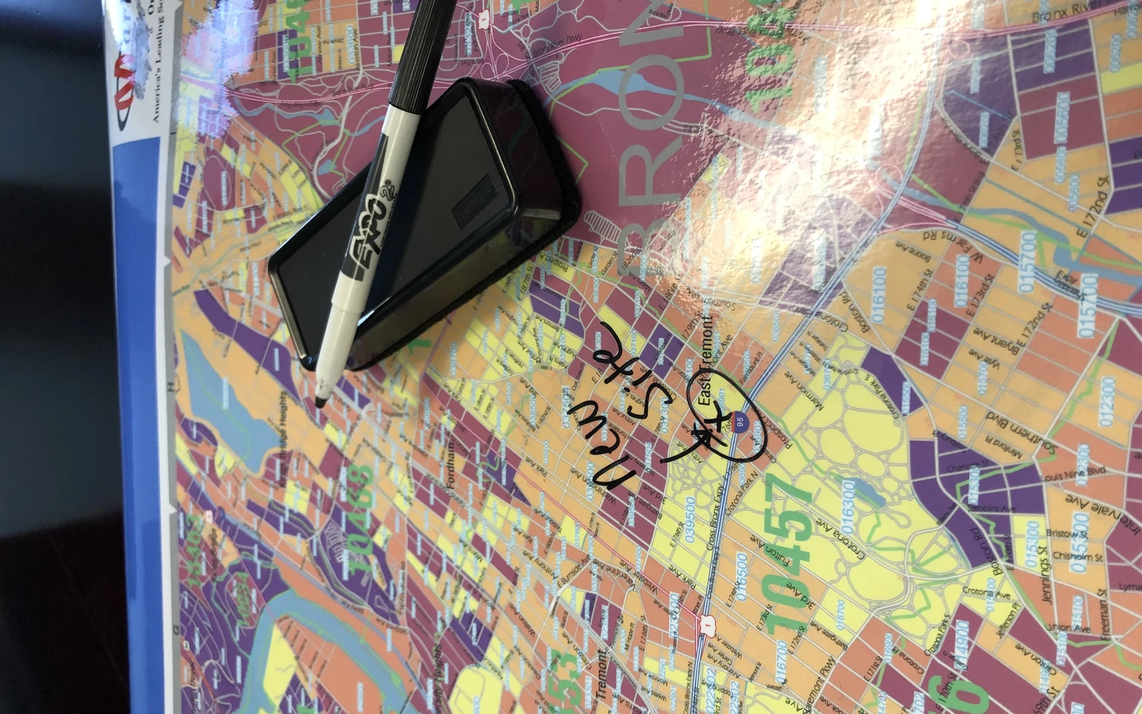 Handwriting wiped across the surface of a glossy laminated map