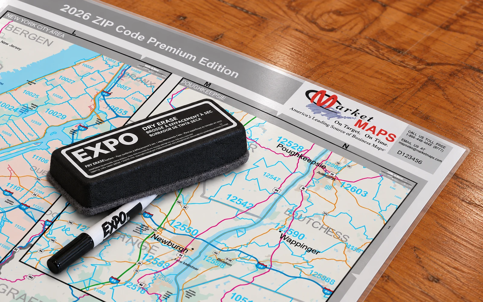 A dry-erase marker and eraser resting on a laminated map
