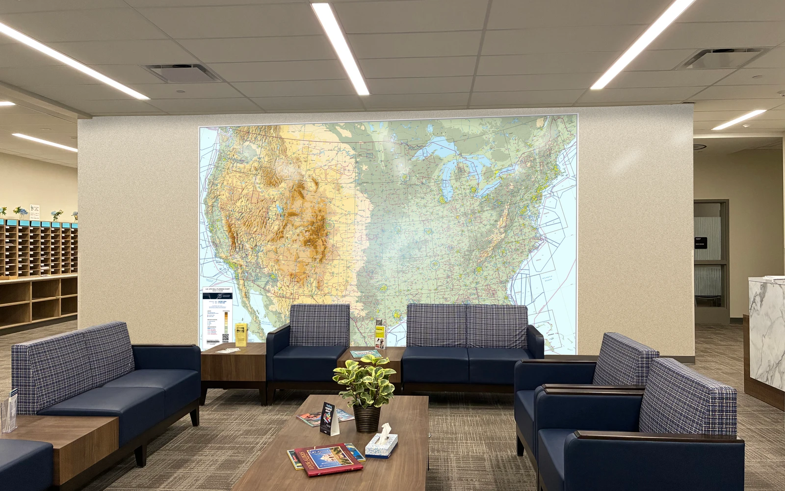 An office lobby with a relief map mural covering the back wall