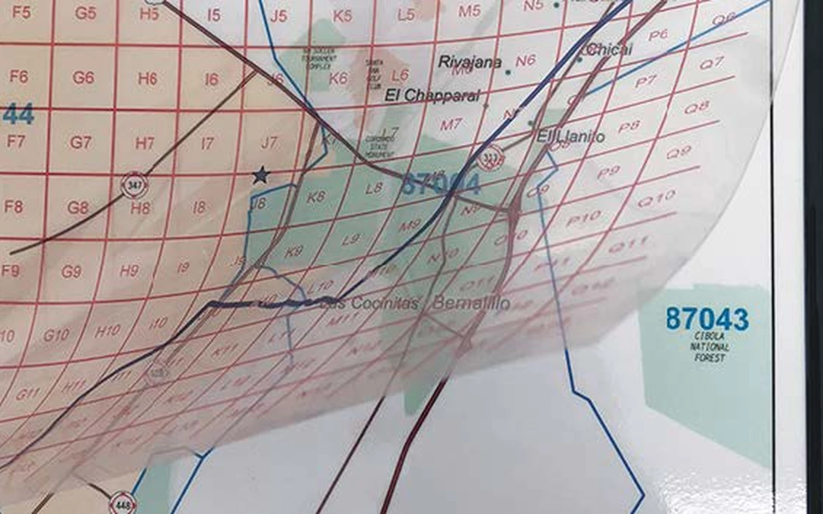 A clear acetate overlay lifted away from the map beneath it