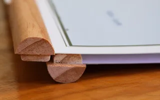 A rounded wooden rail clamped across the bottom edge of a map